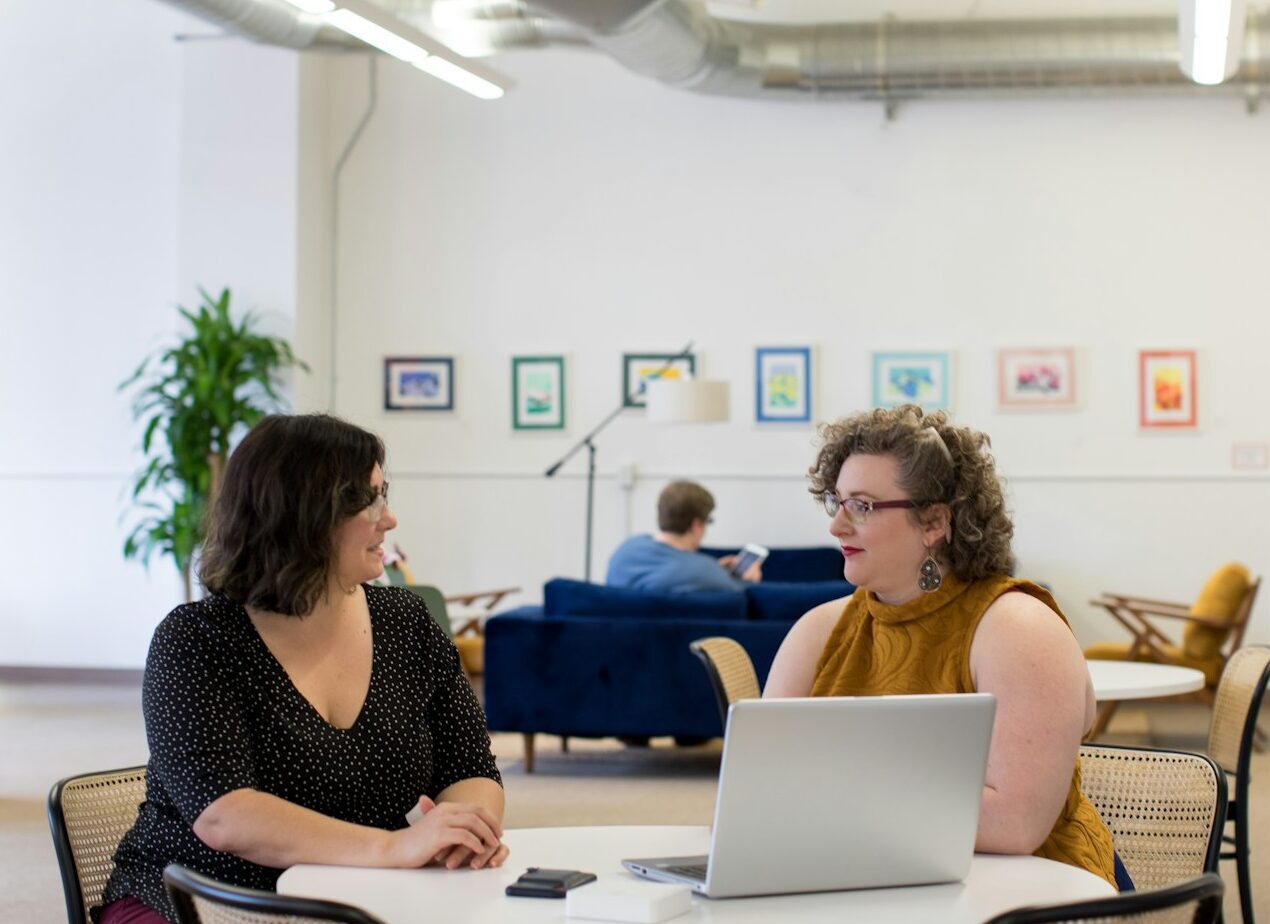 women talking around table